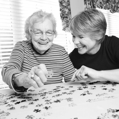 woman and elder lady solving puzzle