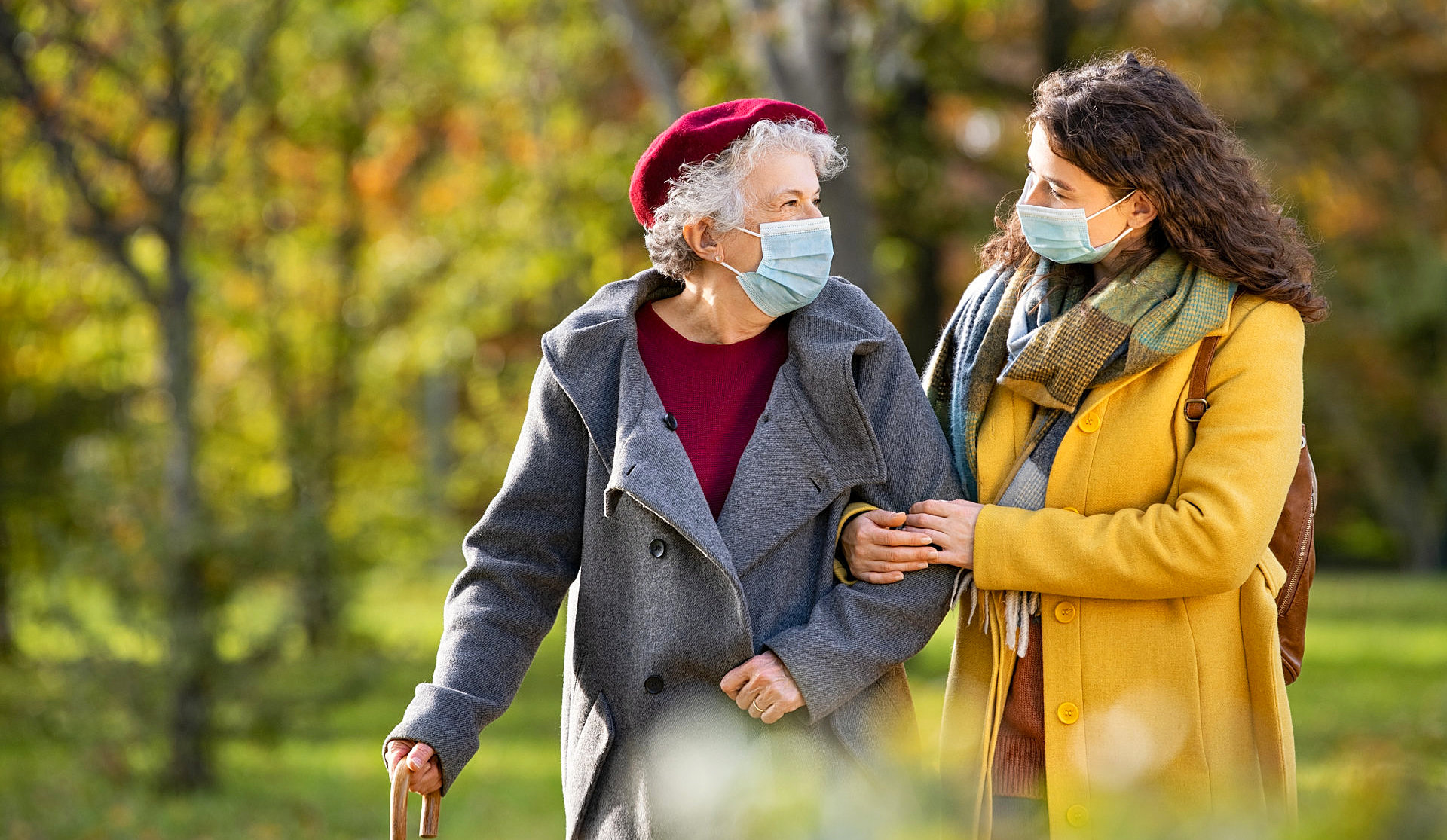 woman and elder lady walking
