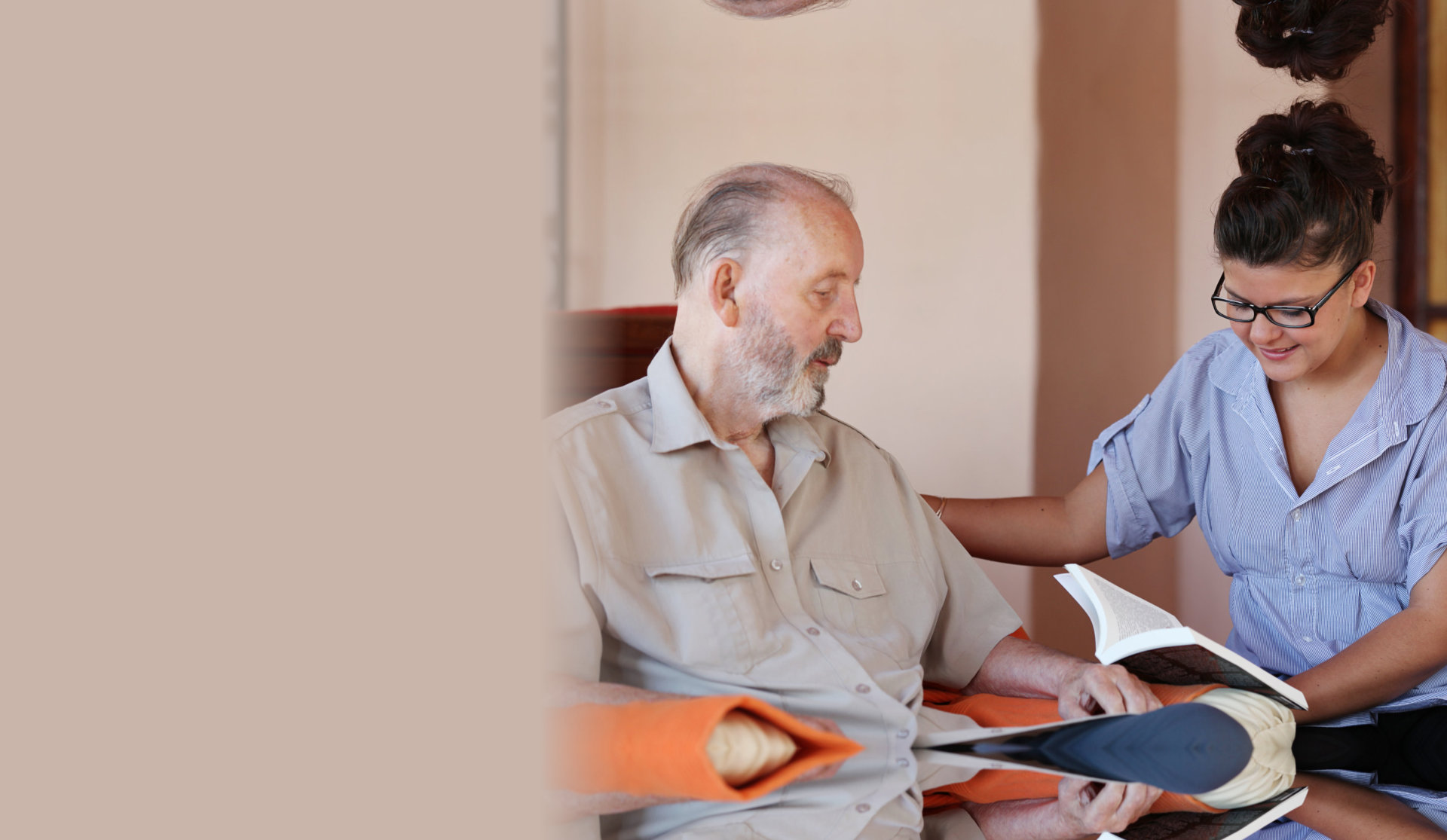 caretaker reads book to elder man